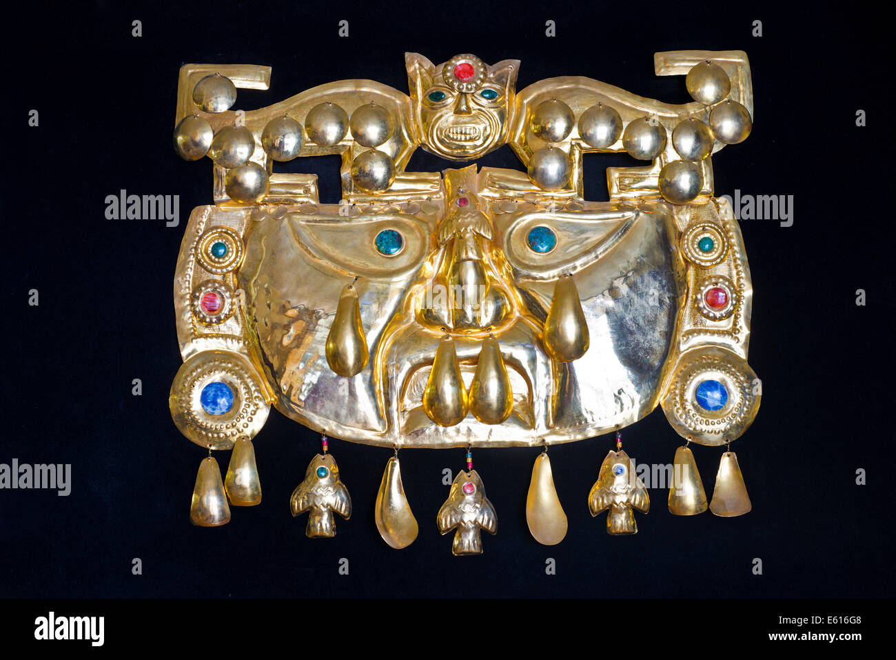 Golden pre-Columbian Inca mask, replica, sheet brass with semi-precious stones, souvenir, Cusco, Peru Stock Photo