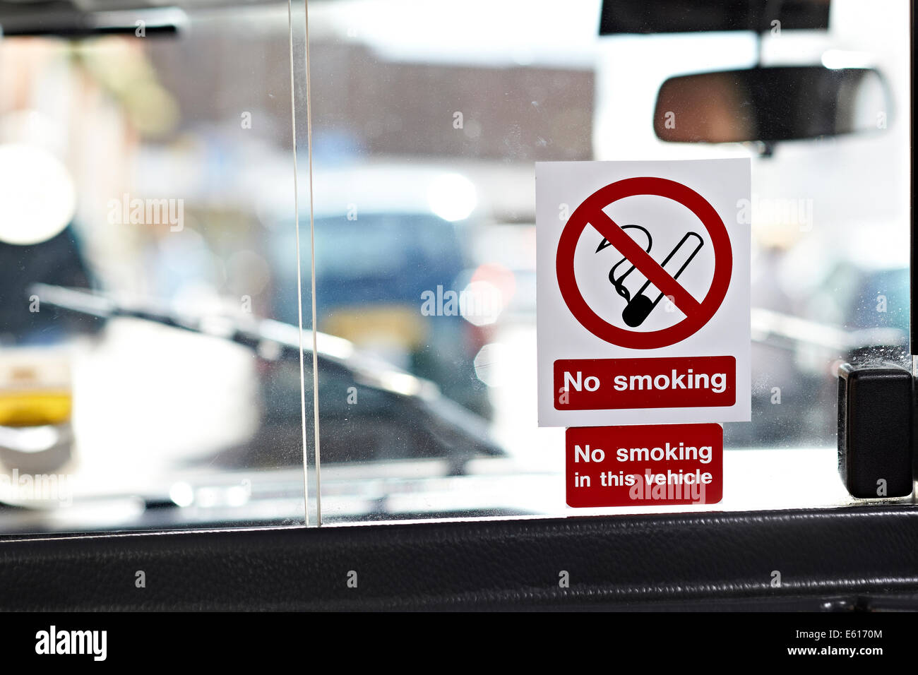 No smoking in this vehicle sign, pictured in a UK taxi or black cab Stock Photo