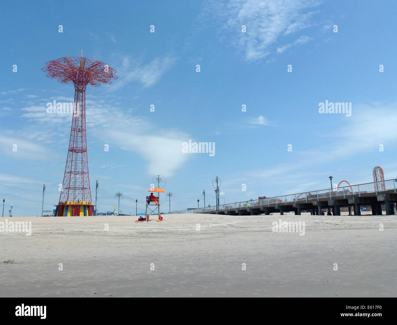 The Parachute Jump (L) and other fairground rides stand at the promenade of Brighton Beach on Coney Island, New York, USA, 24 June 2014. The Parachute Jump is an 80 meters high red steel tower weighing 150 tons. Originally it was part of the New York World Exhibition 1939 in the Flushing Meadows Park and was brought here by the operators of the Steeplechase Park wher it was used until 1968. Since July 1977 the tower is one of the city's landmarks and is under monumental protection since 1989. Photo: Alexandra Schuler - ATTENTION! NO WIRE SERVICE - Stock Photo