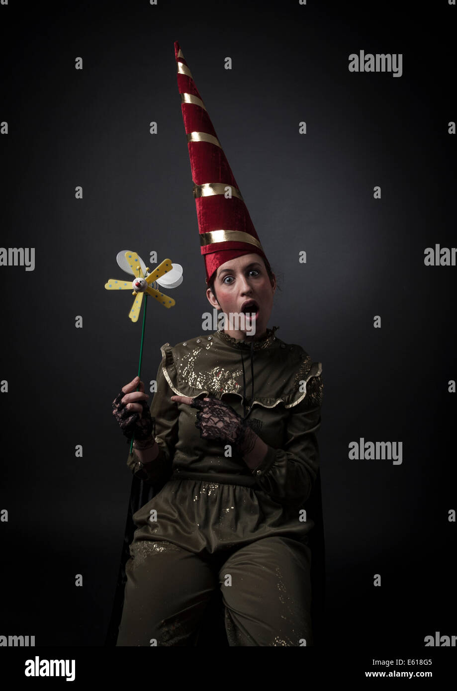 crazy women with capirote (hat tip) and pinwheel. Emblem of Folly. Iconology of Cesare Ripa Stock Photo
