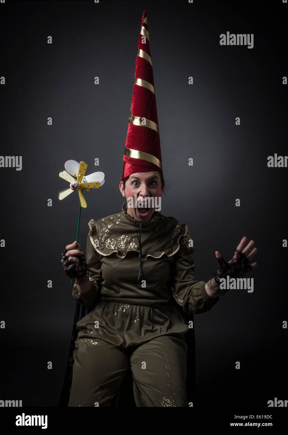 crazy women with capirote (hat tip) and pinwheel Stock Photo