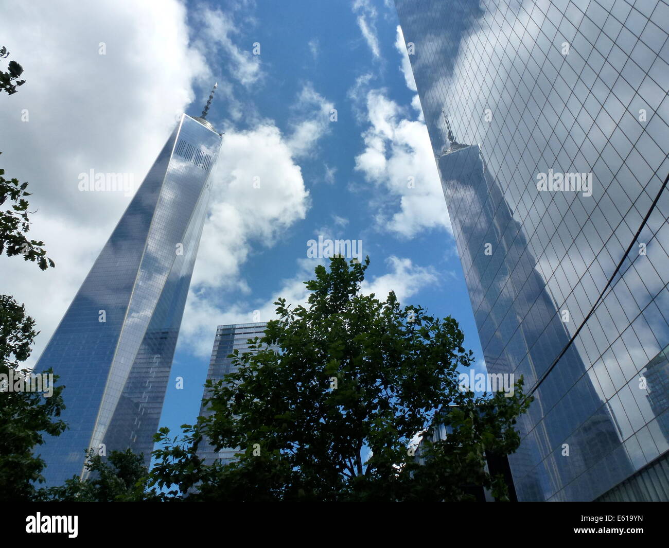 New York City, USA. 20th Aug, 2014. Clouds mirror on the facade of One World Trade Center (WTC 1) (L) office highrise, previously known as the Freedom Tower, in New York City, USA, 20 August 2014. The WTC 1 skyscraper was constructed on the site also known as Ground Zero, which saw the destruction of the World Trade Center in the terrorist attack on 11 September 2001. The building which has been under construction since 2006 is the tallest highrise in the United States, measuring 541.3 metres. Photo: Alexandra Schuler/dpa/Alamy Live News Stock Photo