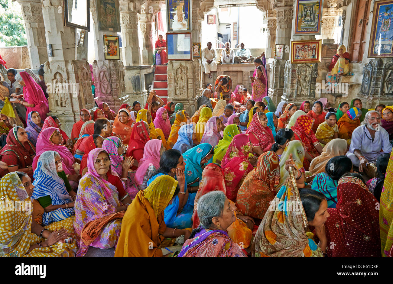 indian hindi women with colorful clothes during ceremony inside Jagdish Temple, Udaipur, Rajasthan, India Stock Photo