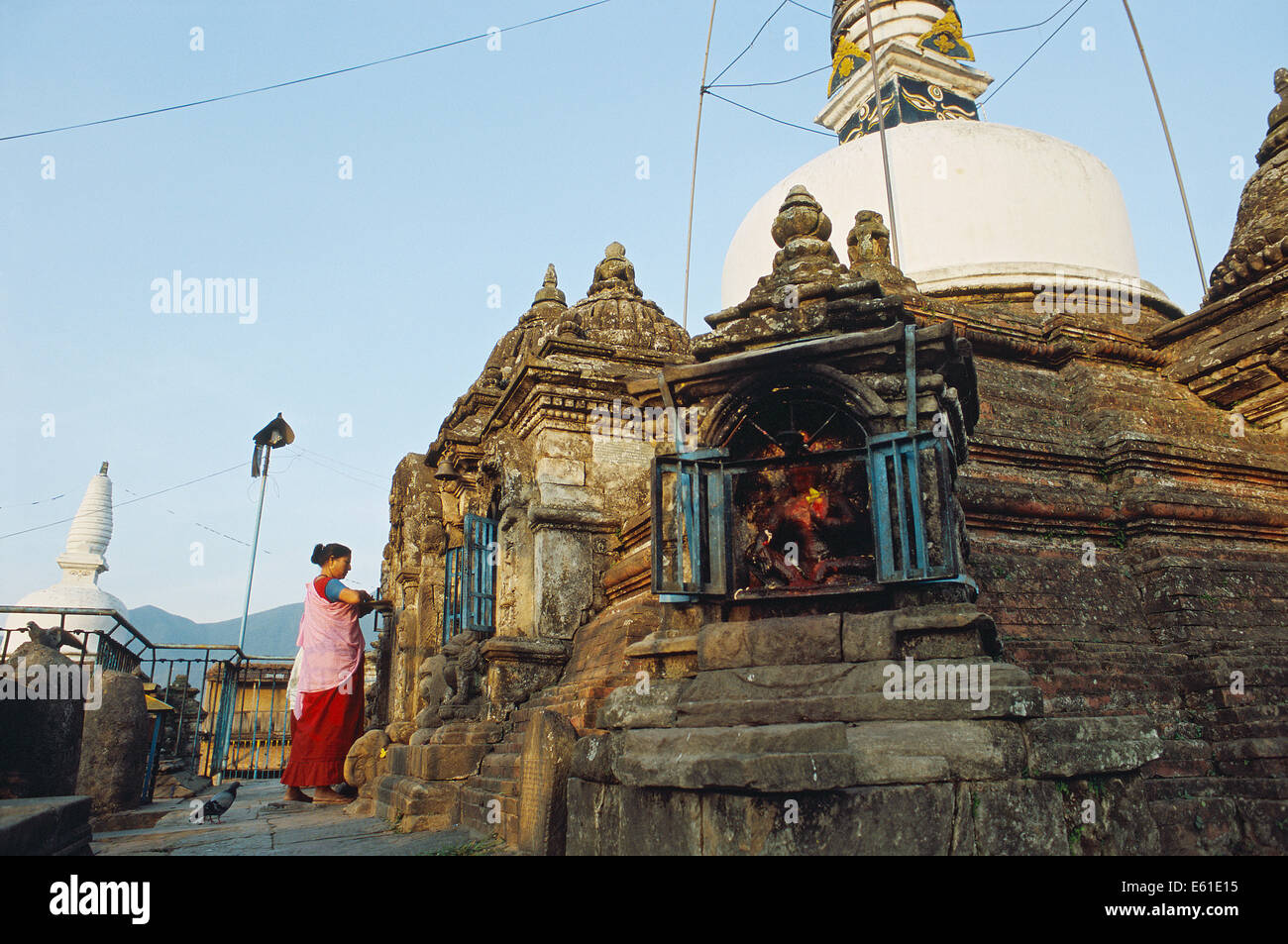 Woman worshiping a deity in a temple. She belongs to the Newari community ( Nepal) Stock Photo
