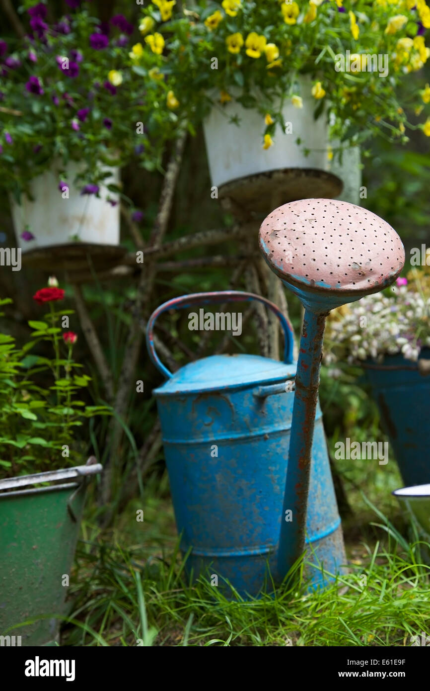 Antique watering can, buckets and flower rack illustrating garden work