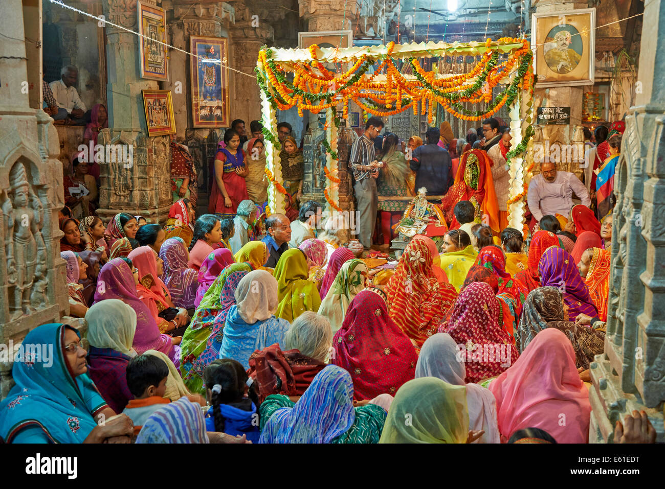 indian hindi women with colorful clothes during ceremony inside Jagdish Temple, Udaipur, Rajasthan, India Stock Photo