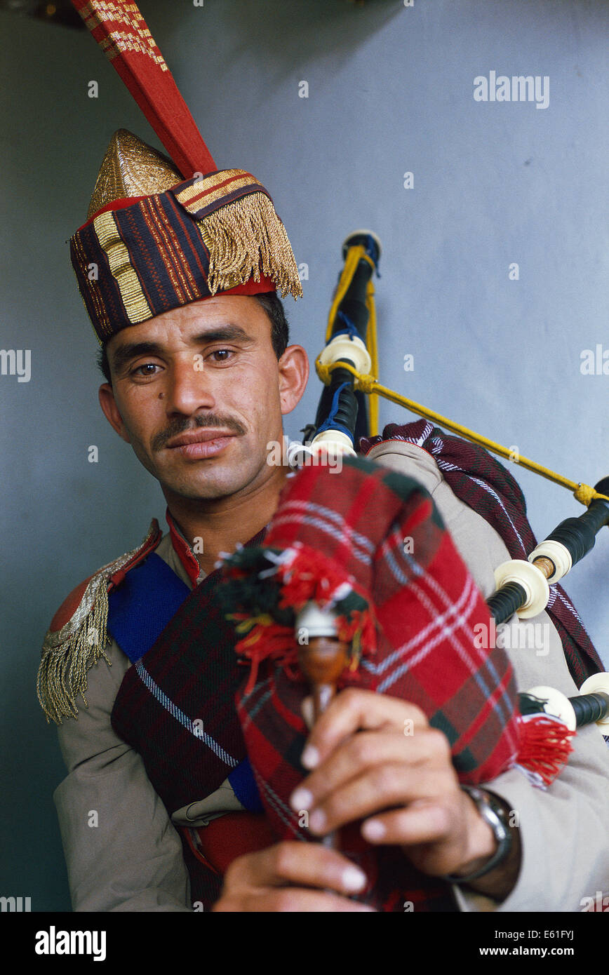 A man wearing a military uniform is playing bagpipe ( Pakistan Stock Photo Alamy