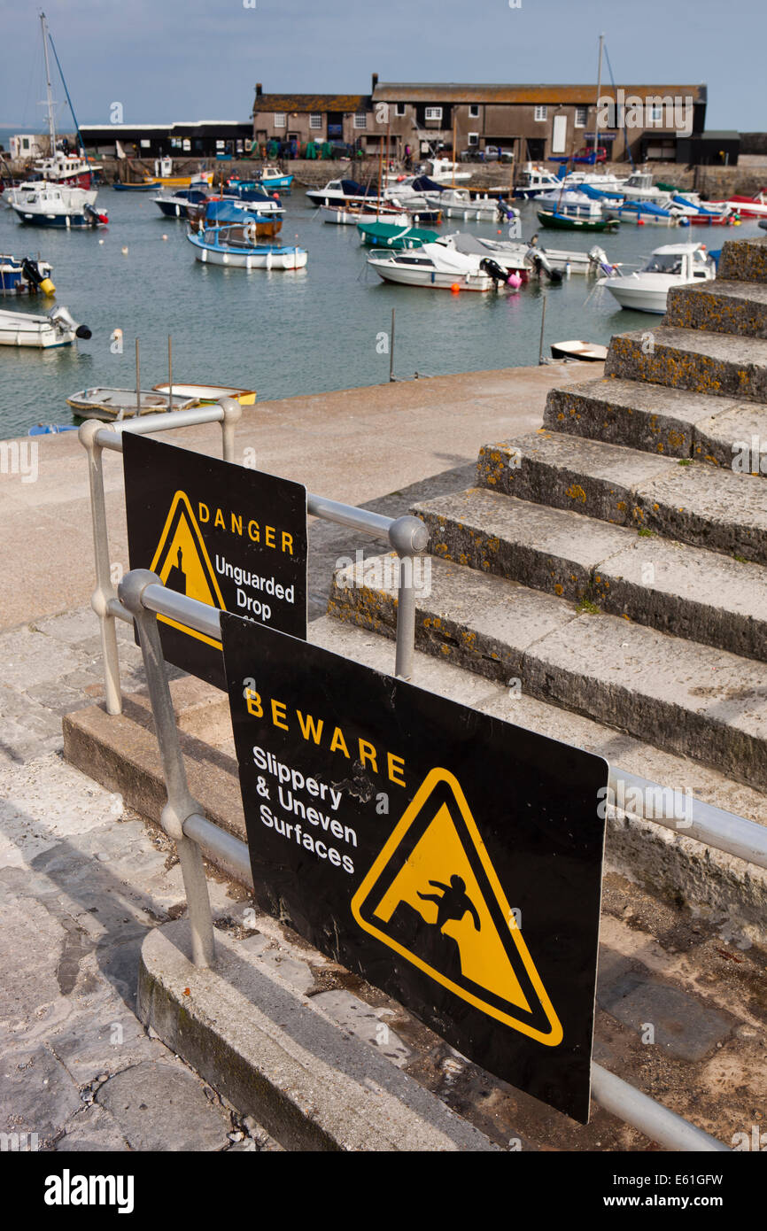 UK England, Dorset, Lyme Regis, Cobb Harbour, health and safety warning notices Stock Photo