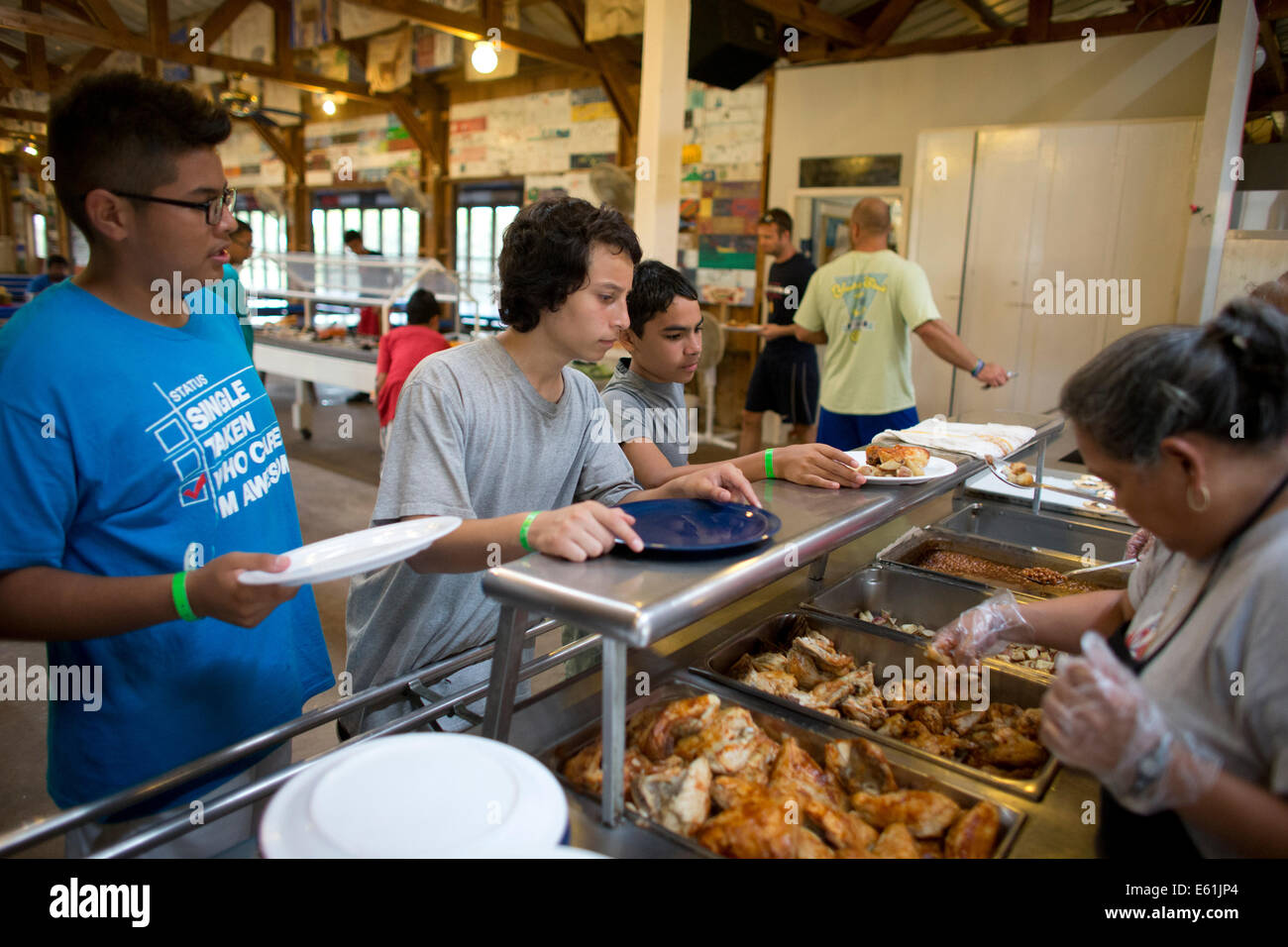 Male campers go through food line during lunch at Camp Champions, a sleep-over summer camp on Lake LBJ in Central TX Stock Photo