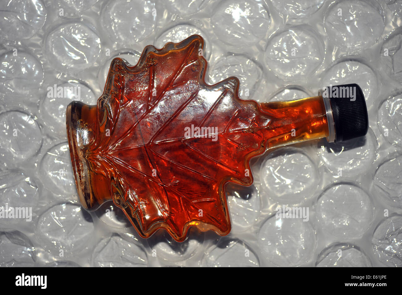 A Canadian maple syrup bottle in the shape of a maple leaf Stock Photo