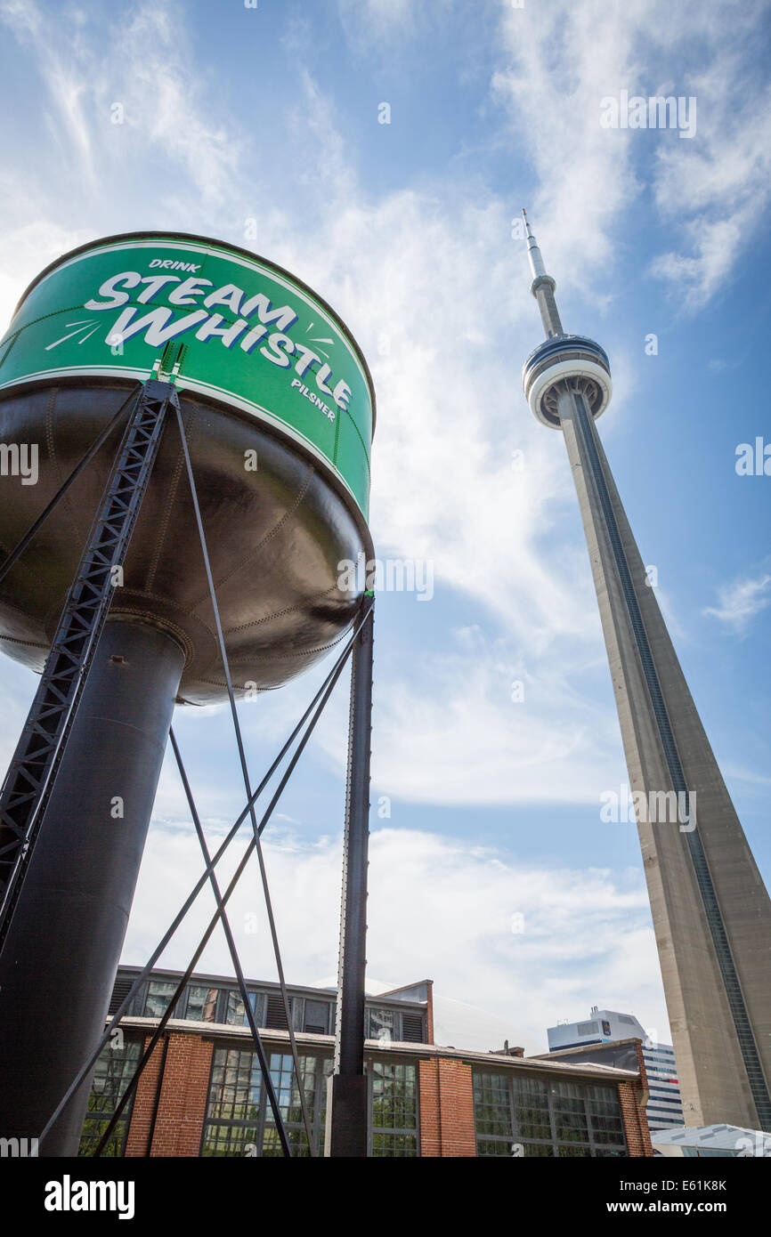 Steam Whistle water tower with the Toronto CN Tower, Toronto, Ontario, Canada, North America. Stock Photo