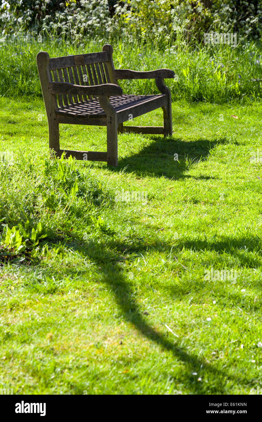 Wooden garden bench on a summery green meadow Stock Photo Alamy
