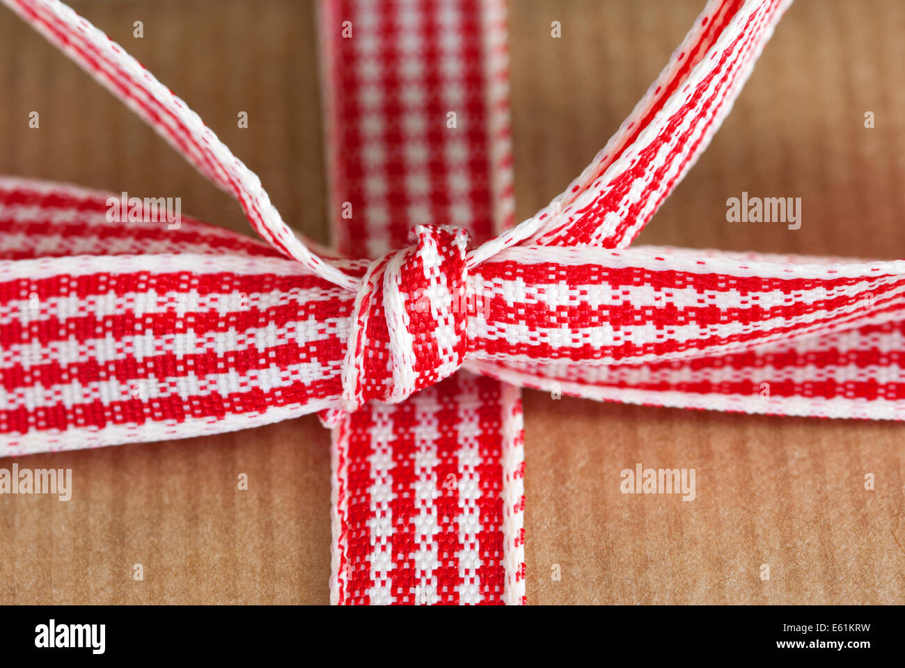 Ribbon Knot Red White as Closeup on a Brown Present Stock Photo - Alamy