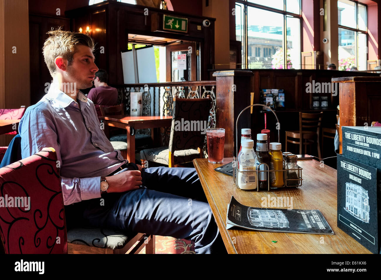 A customer sitting in the Liberty Bounds.  A Weatherspoons pub. Stock Photo