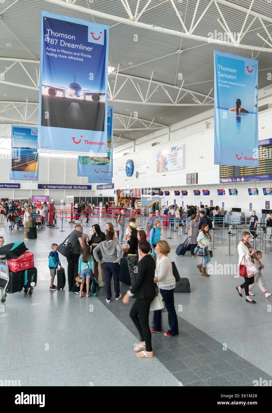 Passengers within the arrivals hall of Newcastle International Airport, north east England, UK Stock Photo