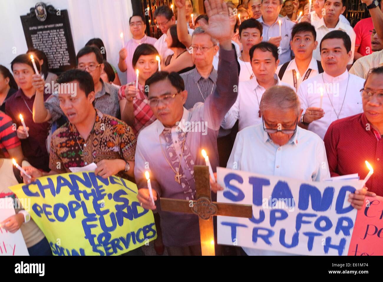 Manila City, Philippines. 11th Aug, 2014. The members of United Methodist Church and other religious groups offer a candle lighting for good governance, truth, justice and accountability in front of Central United Methodist Church in T.M. Kalaw Manila City after the mass, according to the groups it its time that we call for justice and accountability for funds misused by government or its leaders . Credit:  Gregorio B. Dantes Jr/Pacific Press/Alamy Live News Stock Photo