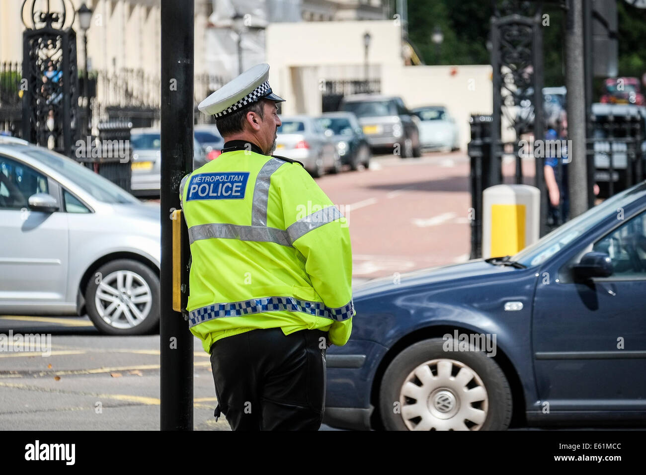 A Metropolitan police officer watching traffic at a junction in London in the UK. Stock Photo