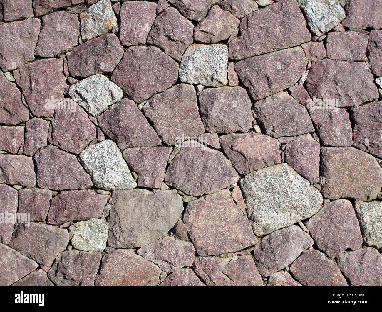 Stone Wall - Dry Set Masonry - Interlocking natural stones are forming a stone wall. Stock Photo
