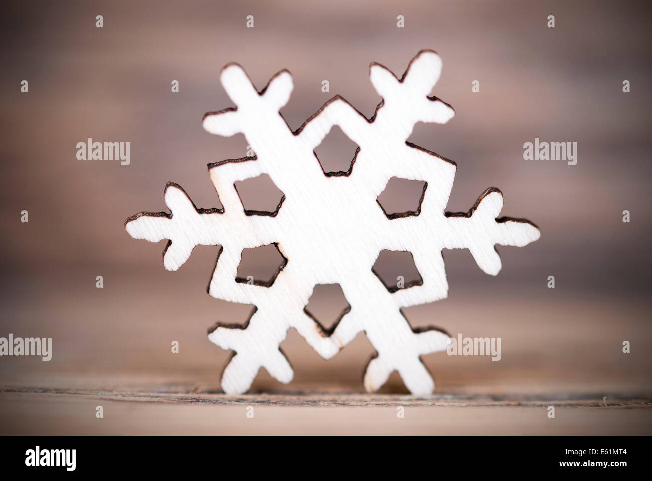 A Single Wooden Snowflake on Wood Background Stock Photo - Alamy