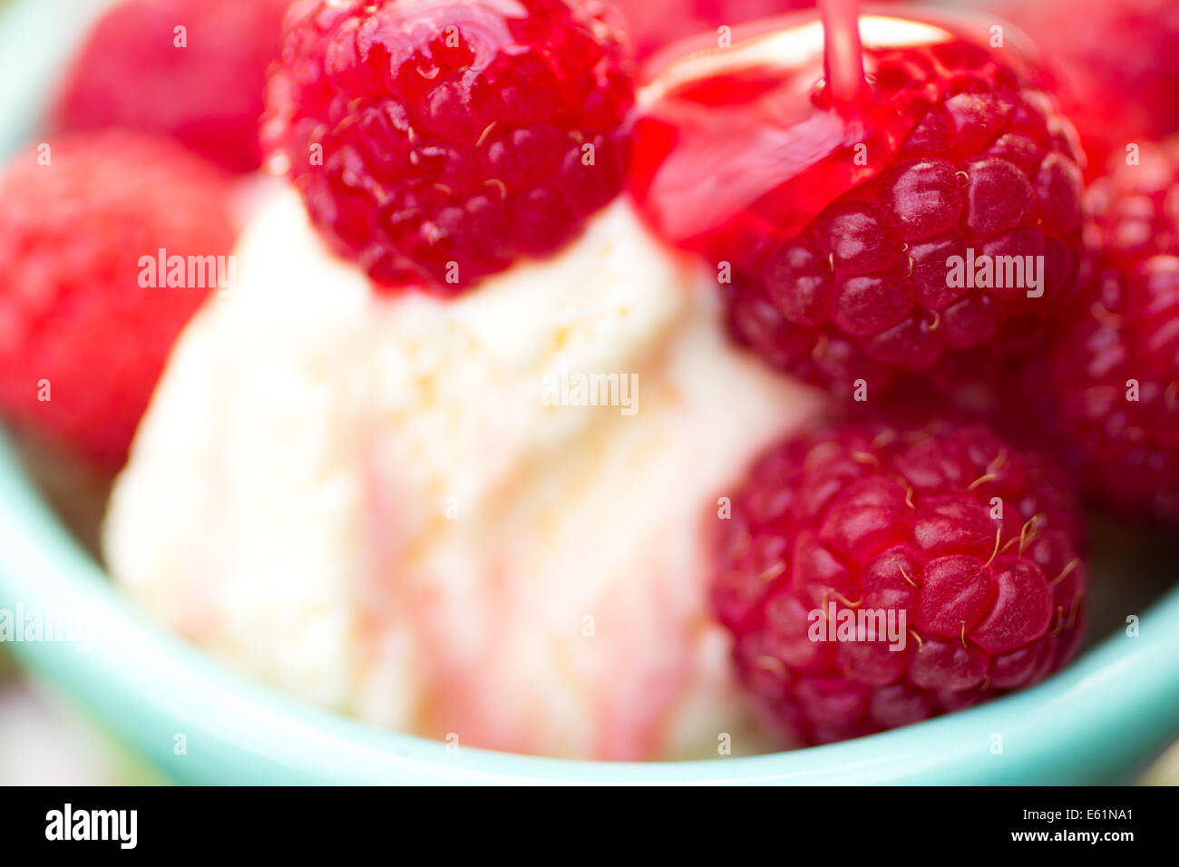 Organic Raspberries on Vanilla Icecream with Raspberry Syrup Stock ...