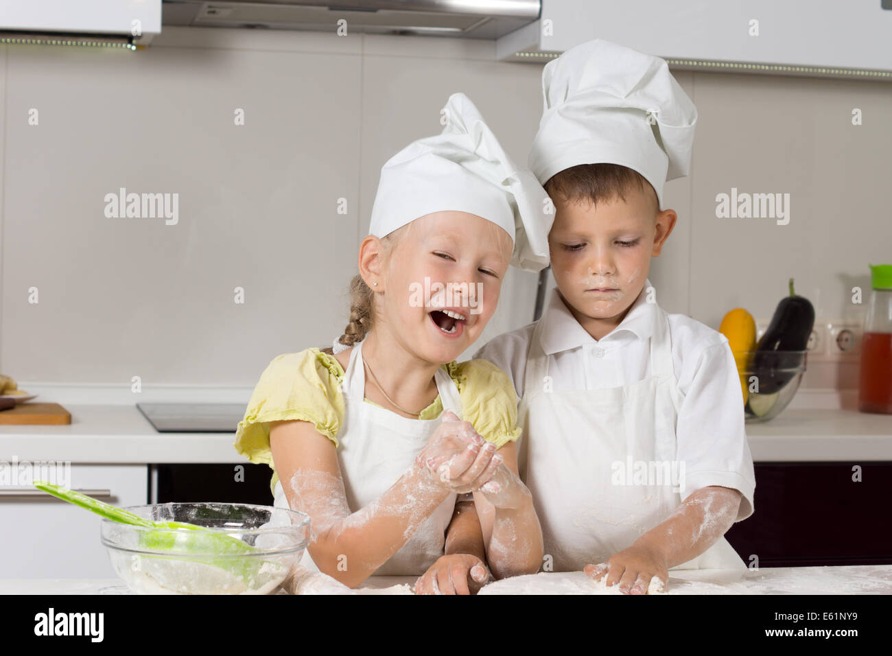 Missy Little Chefs Baking Something to Eat in Kitchen Stock Photo
