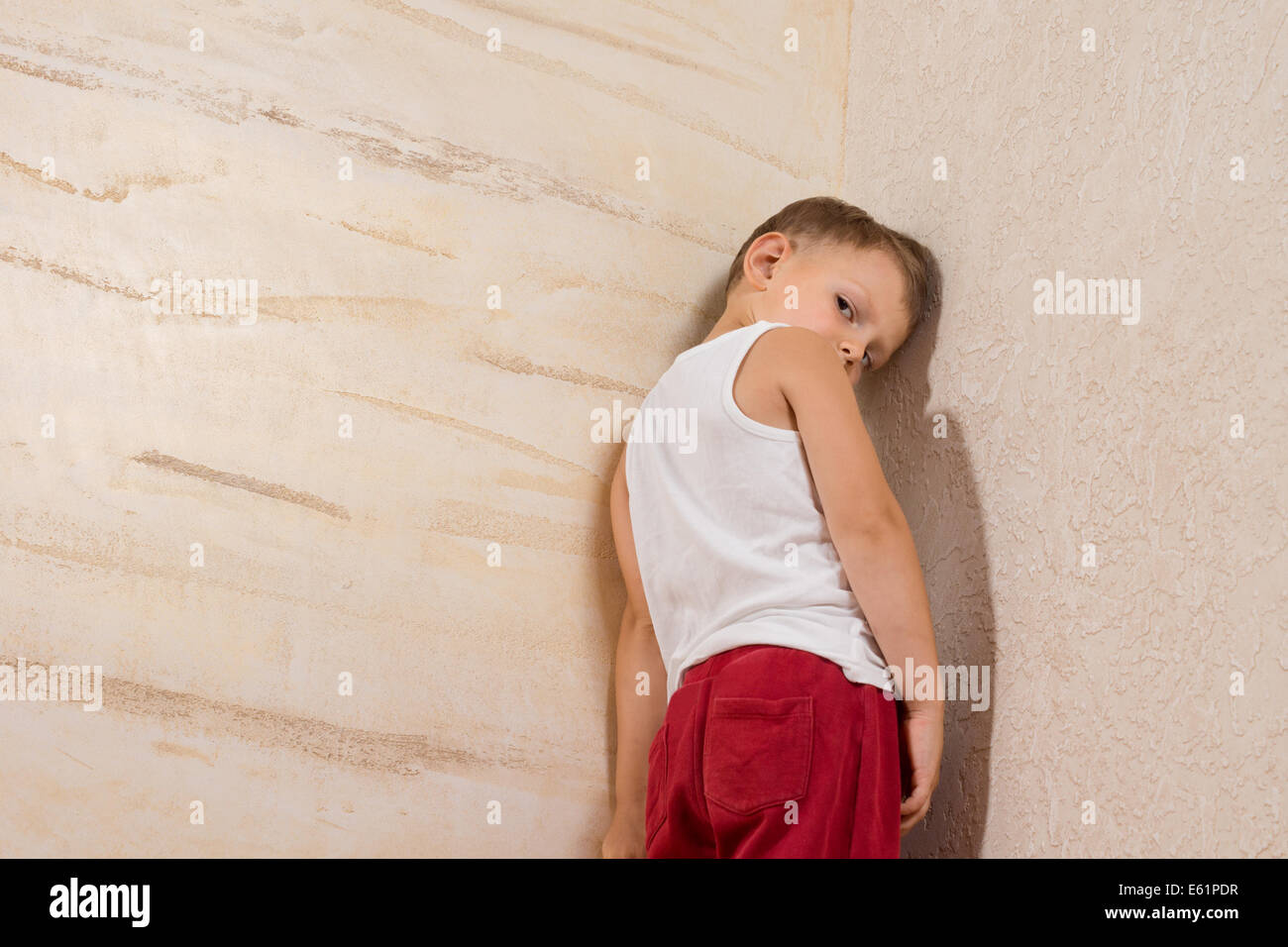 Shy Cute Little Boy Isolated on Wooden Walls. Stock Photo