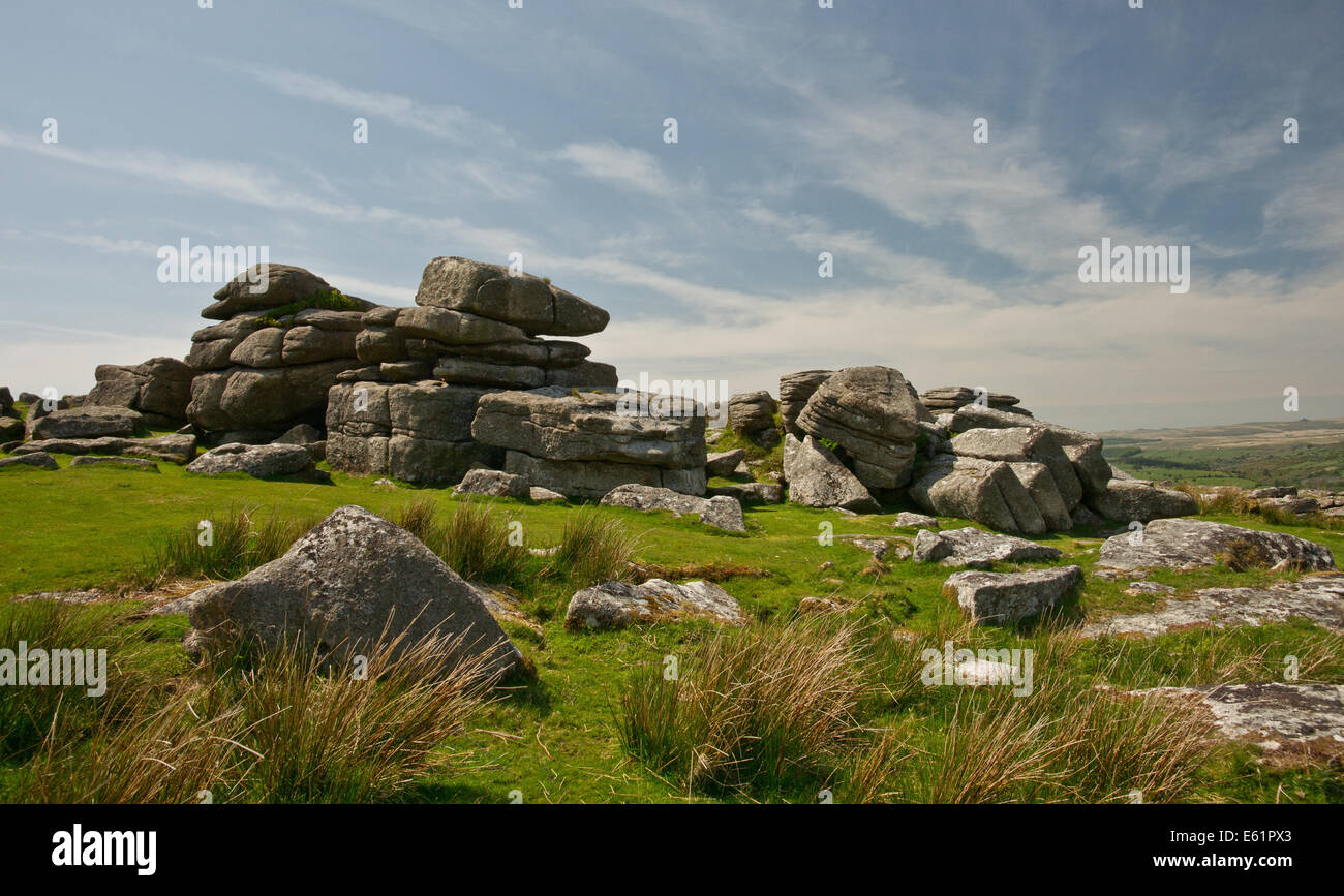 Granite Tor on top of a hill overlooking moorland Stock Photo