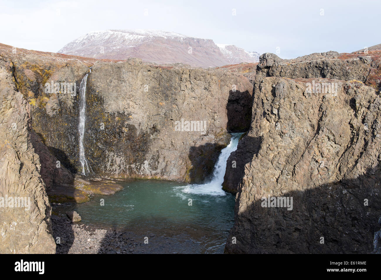 Waterfall and arctic landscape in a rocky environment on Disko Island in Greenland Stock Photo