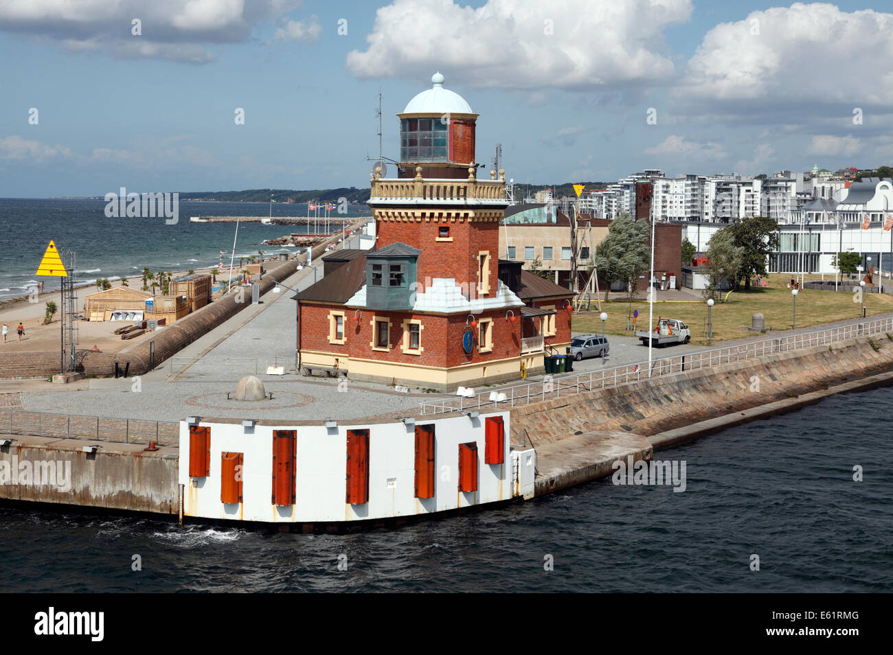 The old pilot station and port harbour lighthouse in Helsingborg Harbour. Left the Tropical Beach. Right residential blocks. Stock Photo