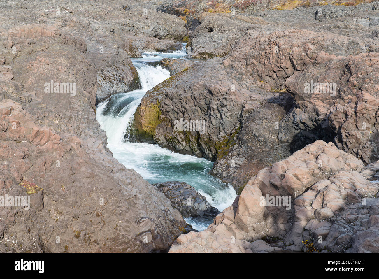 Closeup of a waterfall in a rocky environment on Disko Island in Greenland Stock Photo