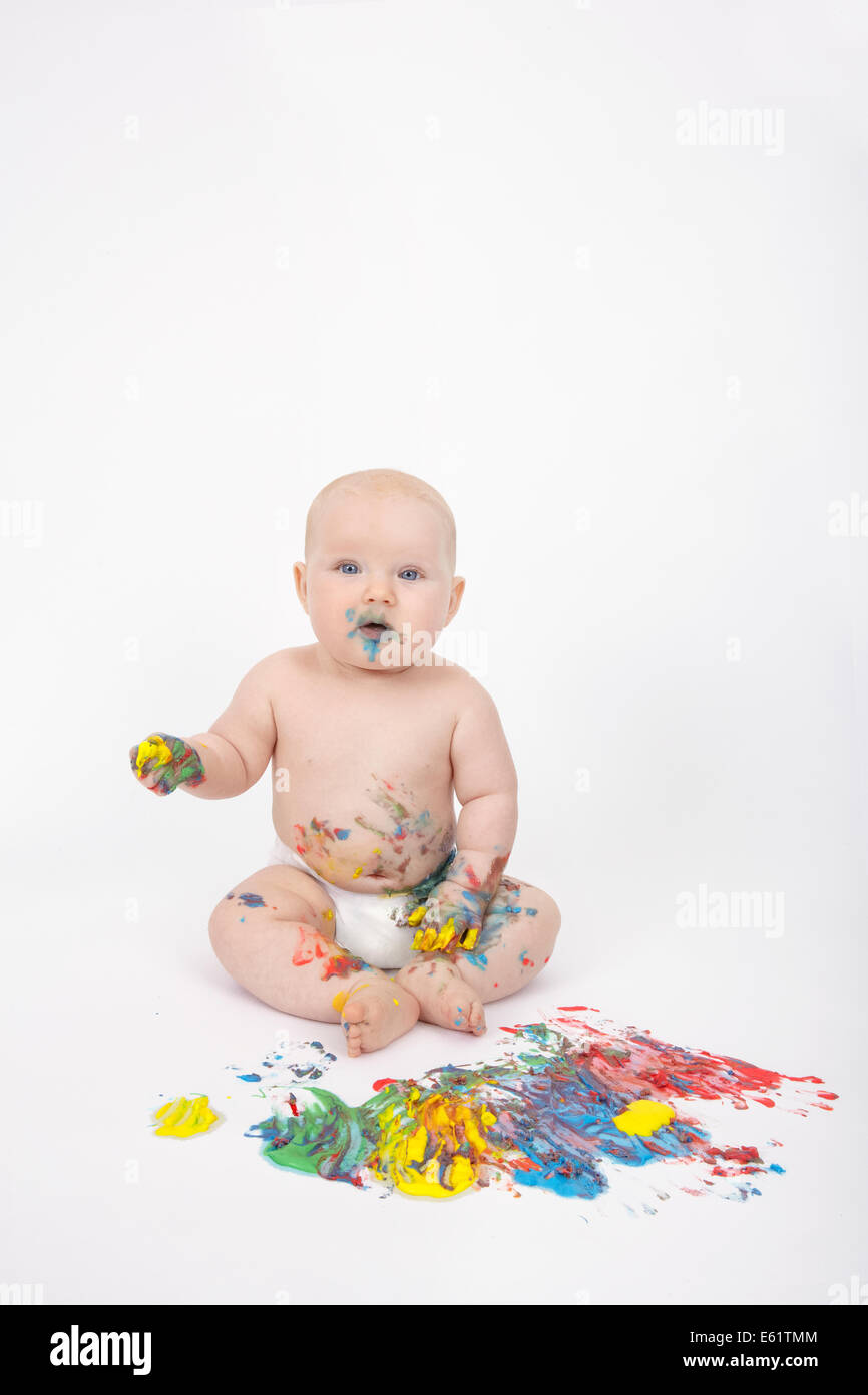Baby girl (6-11 months) playing with plasticine Stock Photo