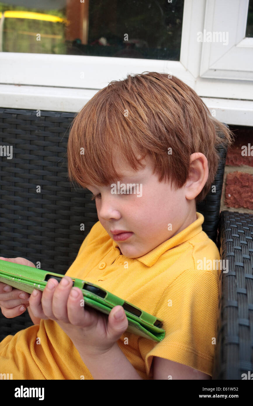 A 5-year old caucasian boy using an iPad tablet device Stock Photo - Alamy