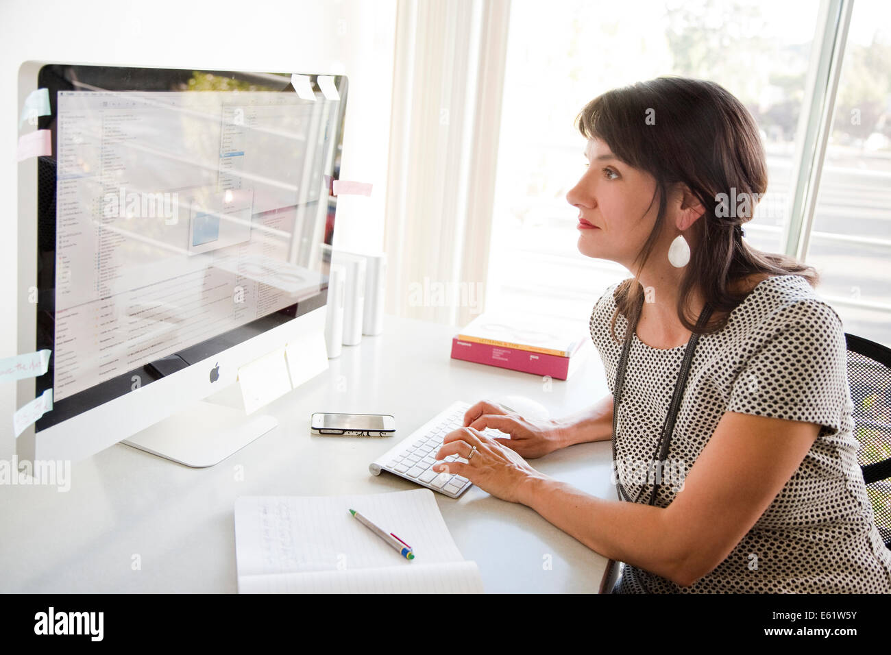 Businesswoman working at her desk in office Stock Photo - Alamy