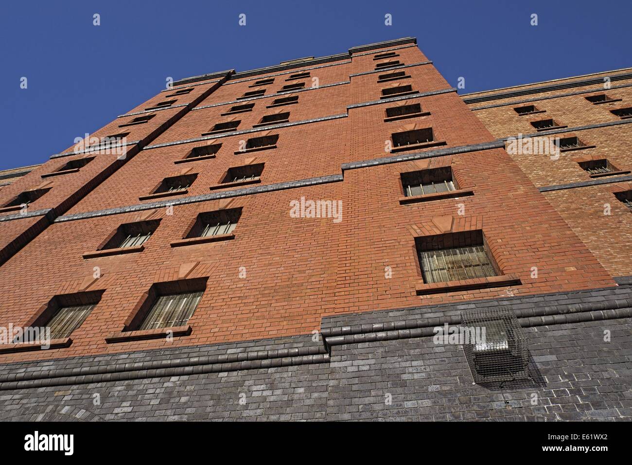 One of several old customs warehouses in the city of Bristol old dock area ,viewed upwards showing a blue sky above. Stock Photo