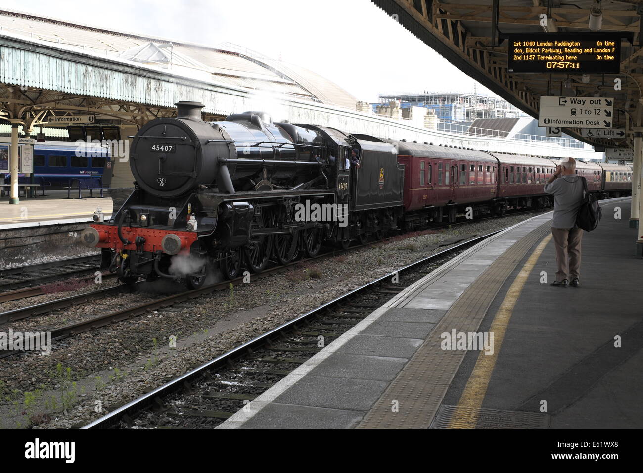 old train spotter photographing a steam locomotive at the head of a steam special at Temple Meads railway station. Stock Photo