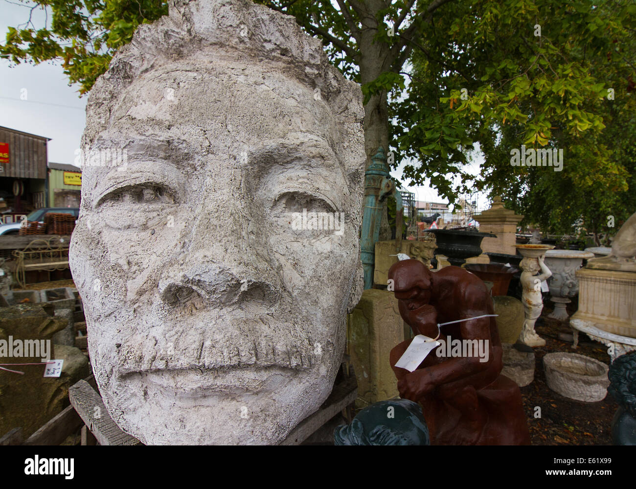 Giant six foot stone head of Lu Xun in Reclamation yard in Wells Somerset Stock Photo