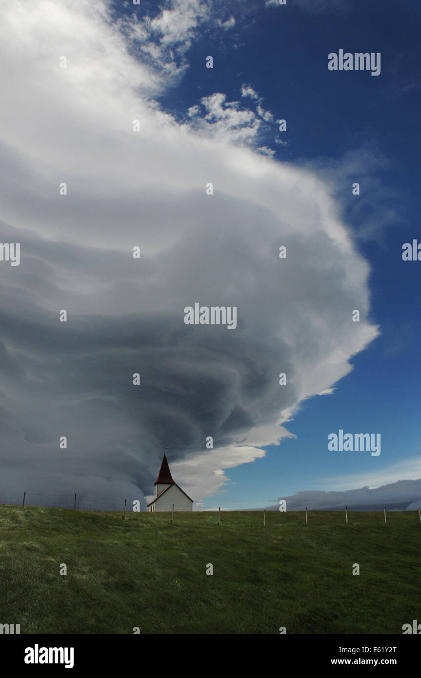 Church in Hellnar under dramatic wind whipped storm cloud below Snæfellsjoekull Mountain on Snæfellsnes Peninsula, Iceland, Stock Photo