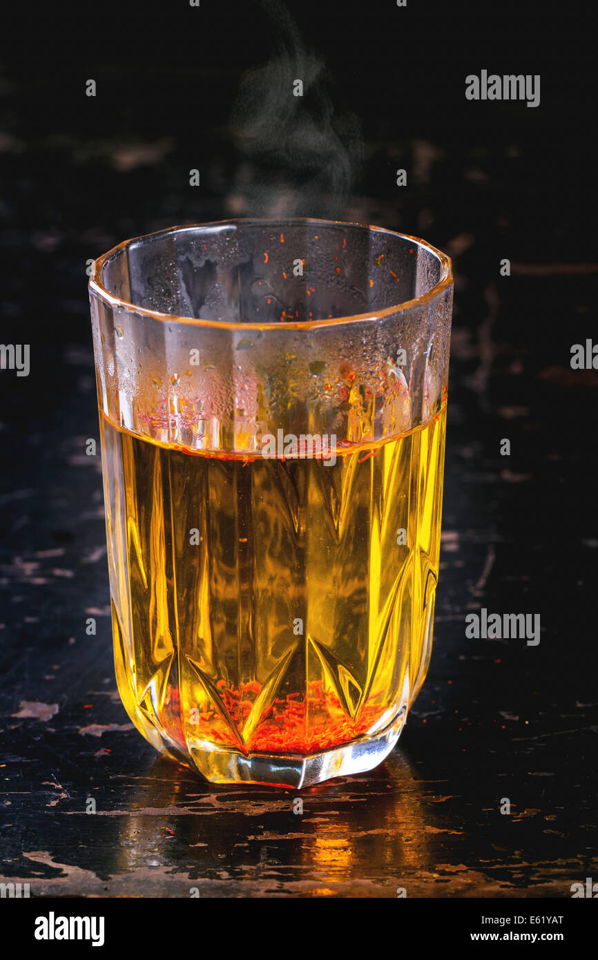 Vintage glass with saffron hot water. Stock Photo
