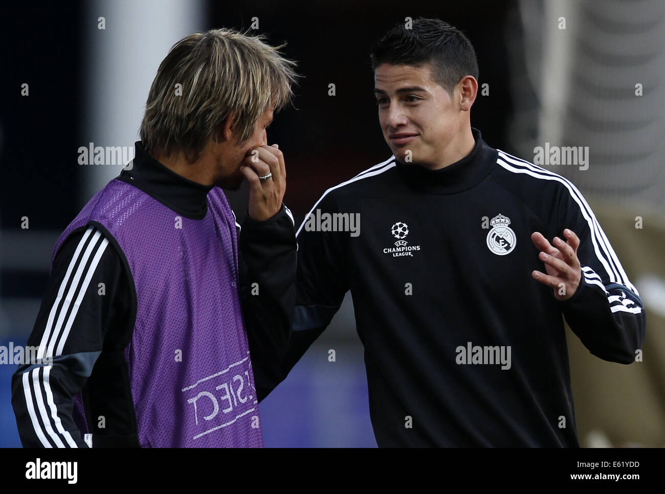 Cardiff. 11th Aug, 2014. James Rodriguez(R) of Real Madrid talks with his teammate Fabio Coentrao during a training session for the UEFA Super Cup match between Real Madrid and Sevilla at Cardiff City Stadium in Cardiff, Britain on Aug. 11, 2014. © Wang Lili/Xinhua/Alamy Live News Stock Photo