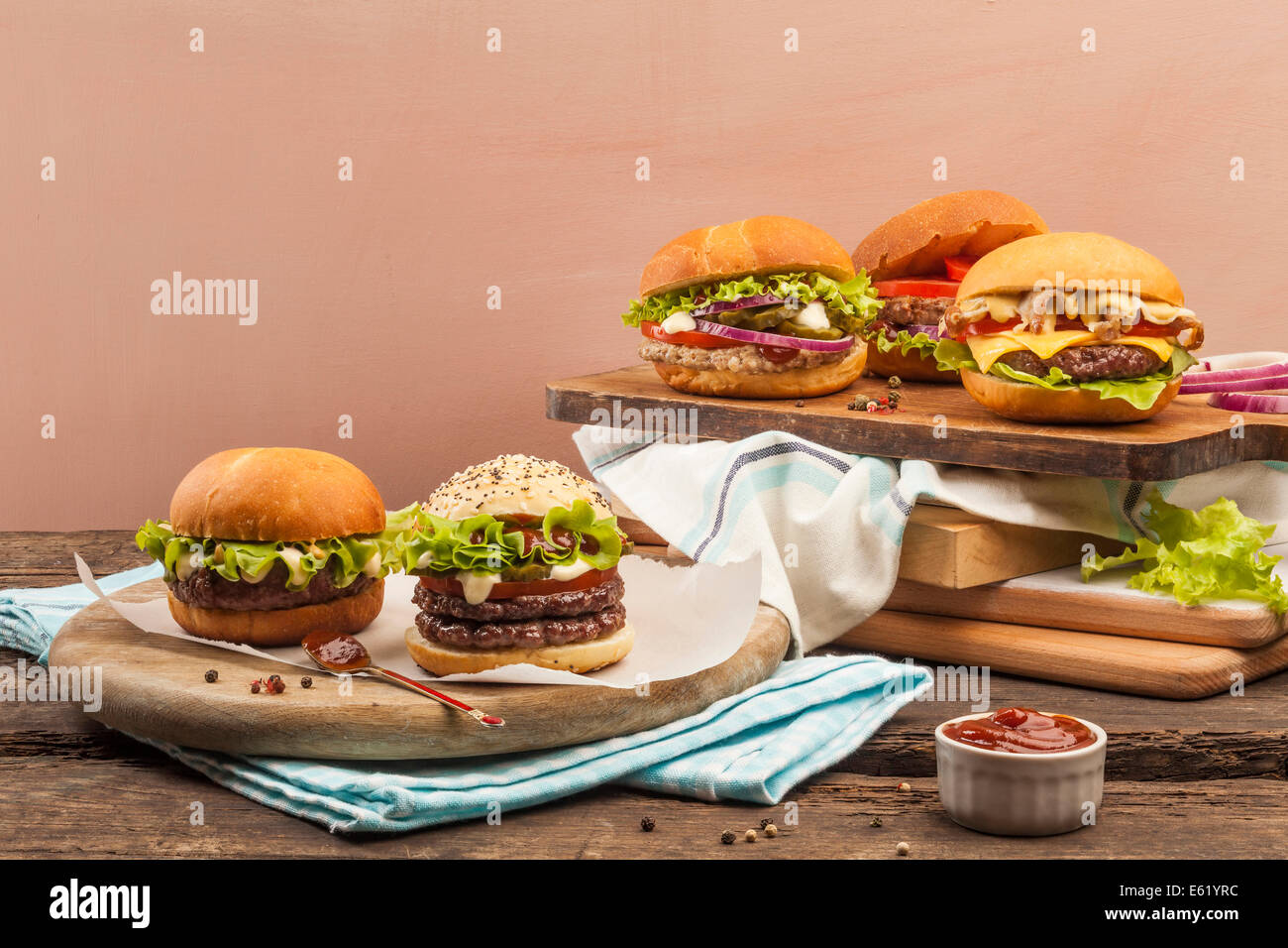 Five different gourmet burgers on wooden background Stock Photo