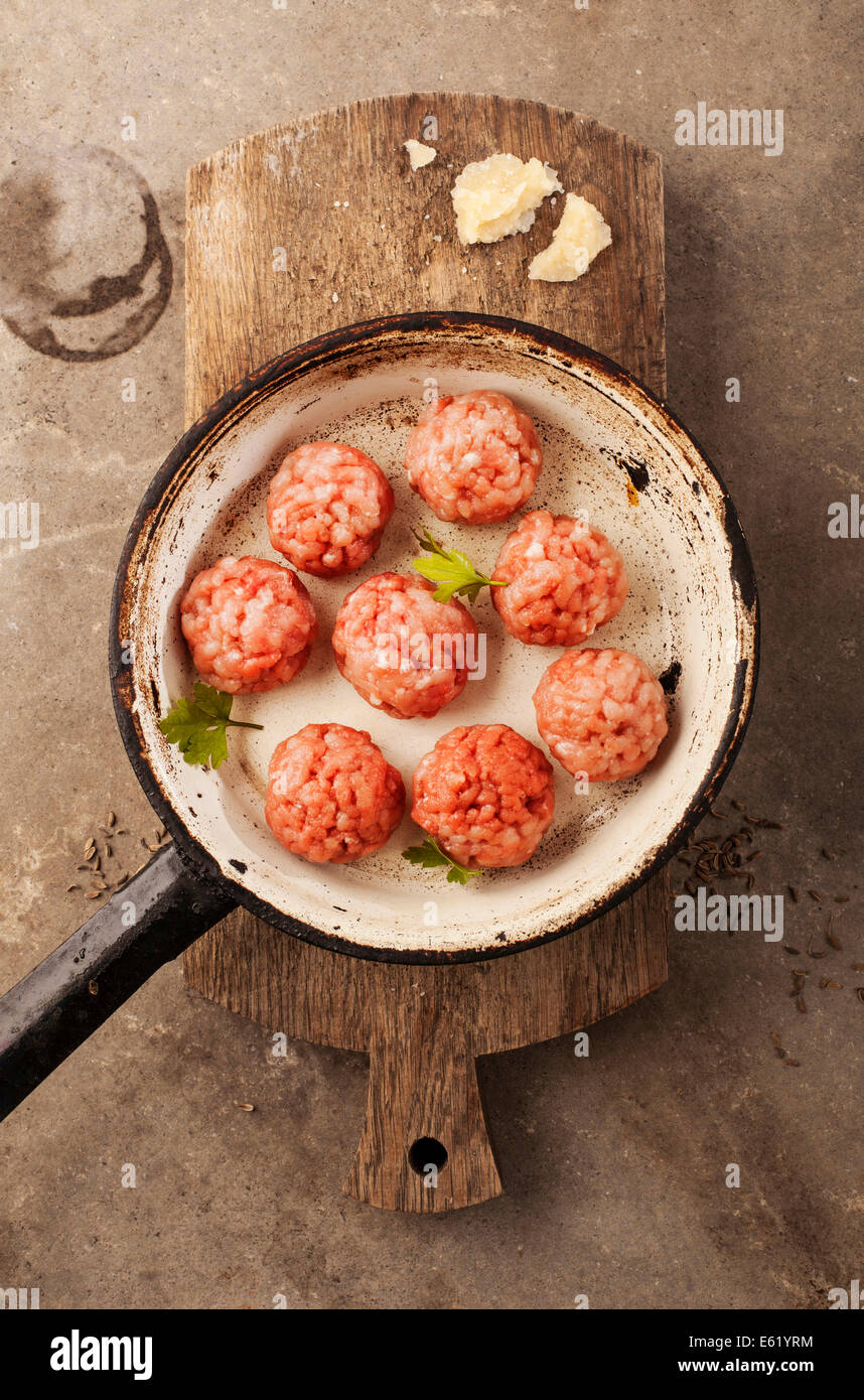 Meatballs cooking with mince, parsley, parmesan, wine and eggs. Stock Photo