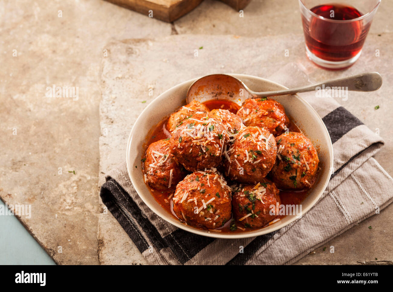 Meatballs cooked in tomato sauce in bowl on grey backround Stock Photo
