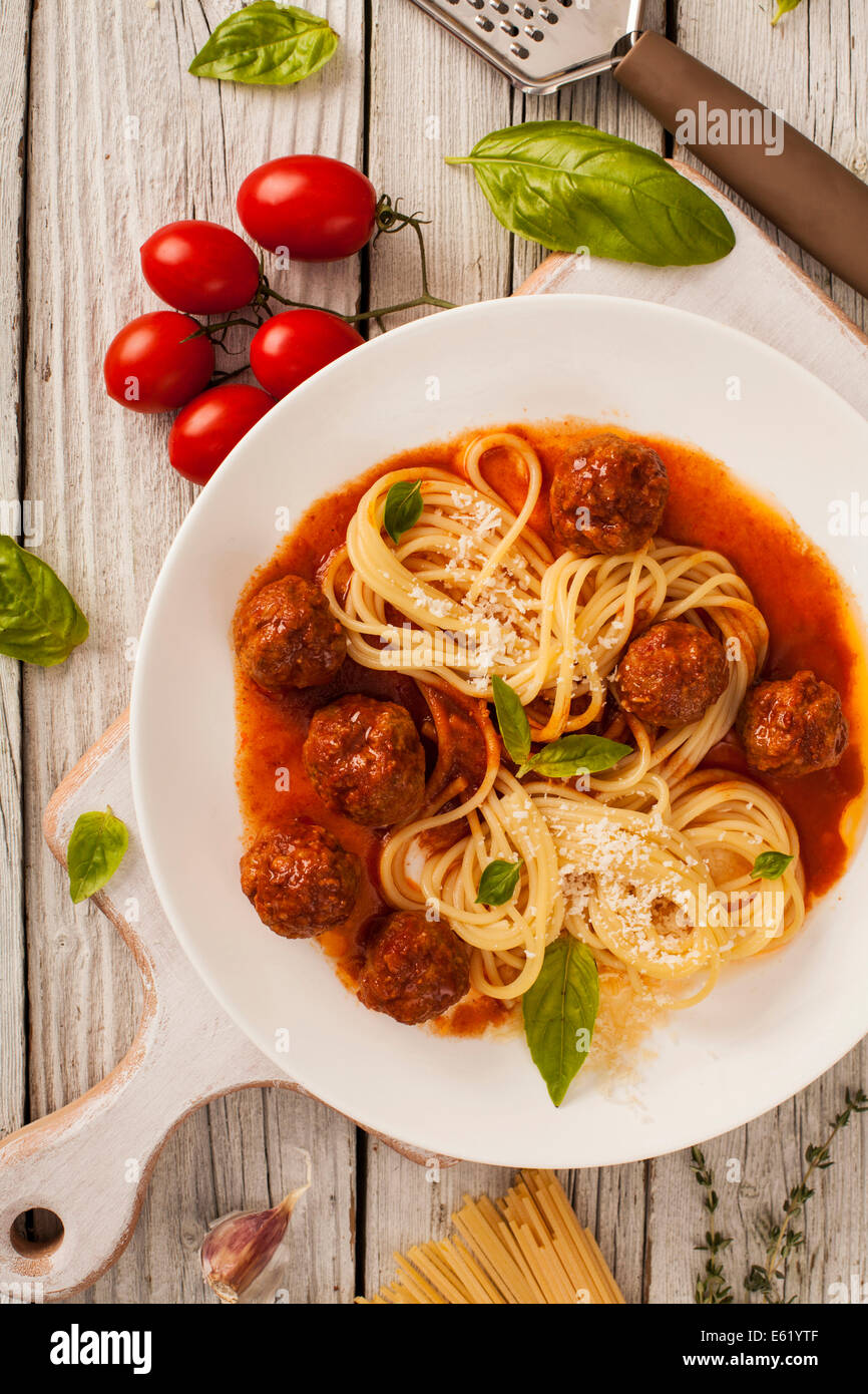 Pasta with meatballs with fresh basil and tomato sauce Stock Photo