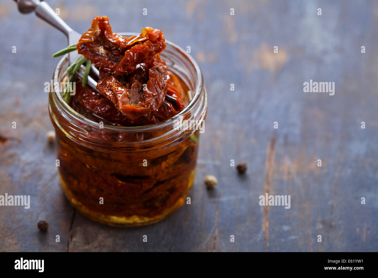 Sundried tomatoes in jar on wooden background Stock Photo Alamy
