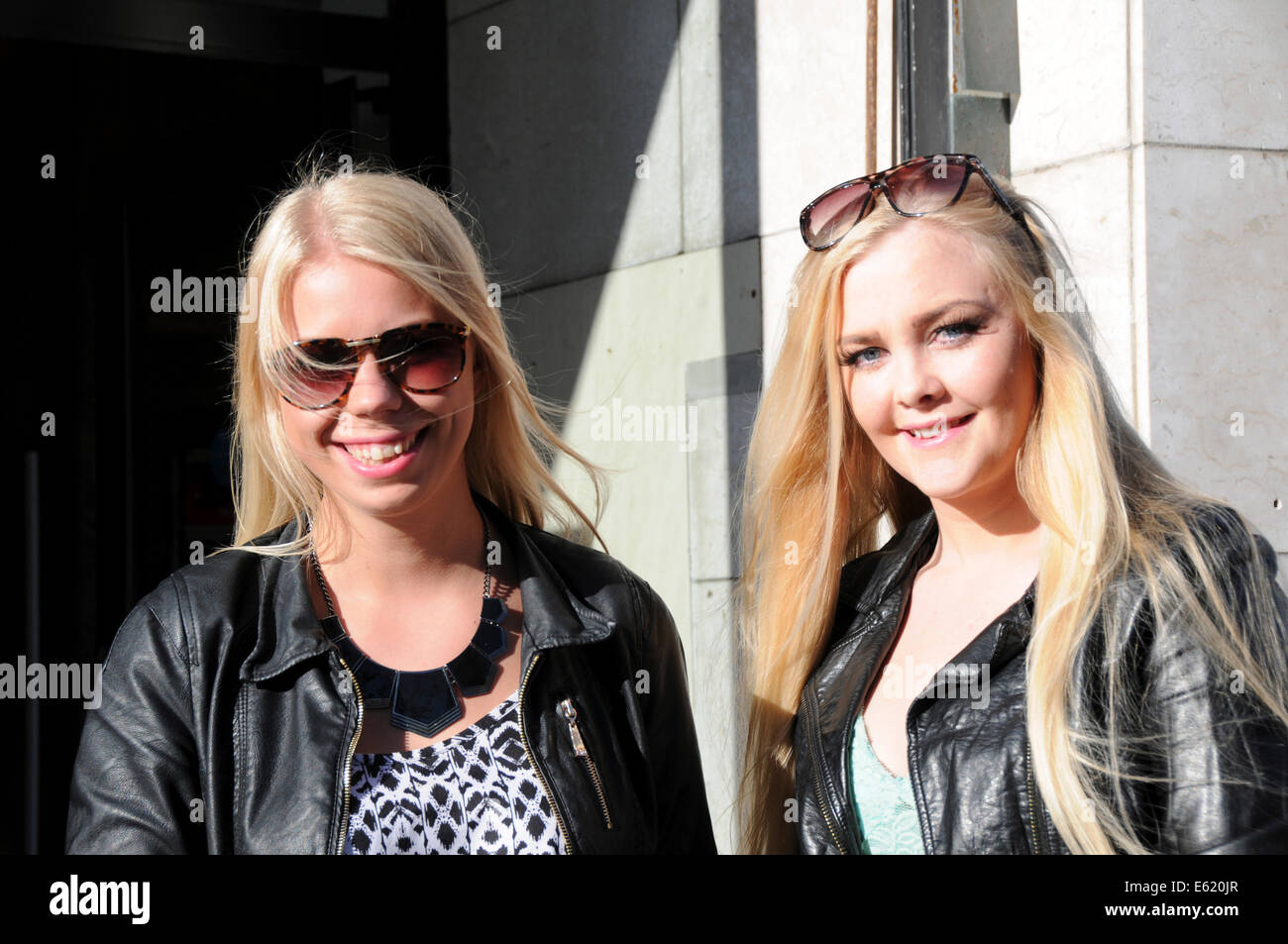 People and faces along streets of Reykjavik in Iceland. Two lovely blond Icelandic ladies. Stock Photo