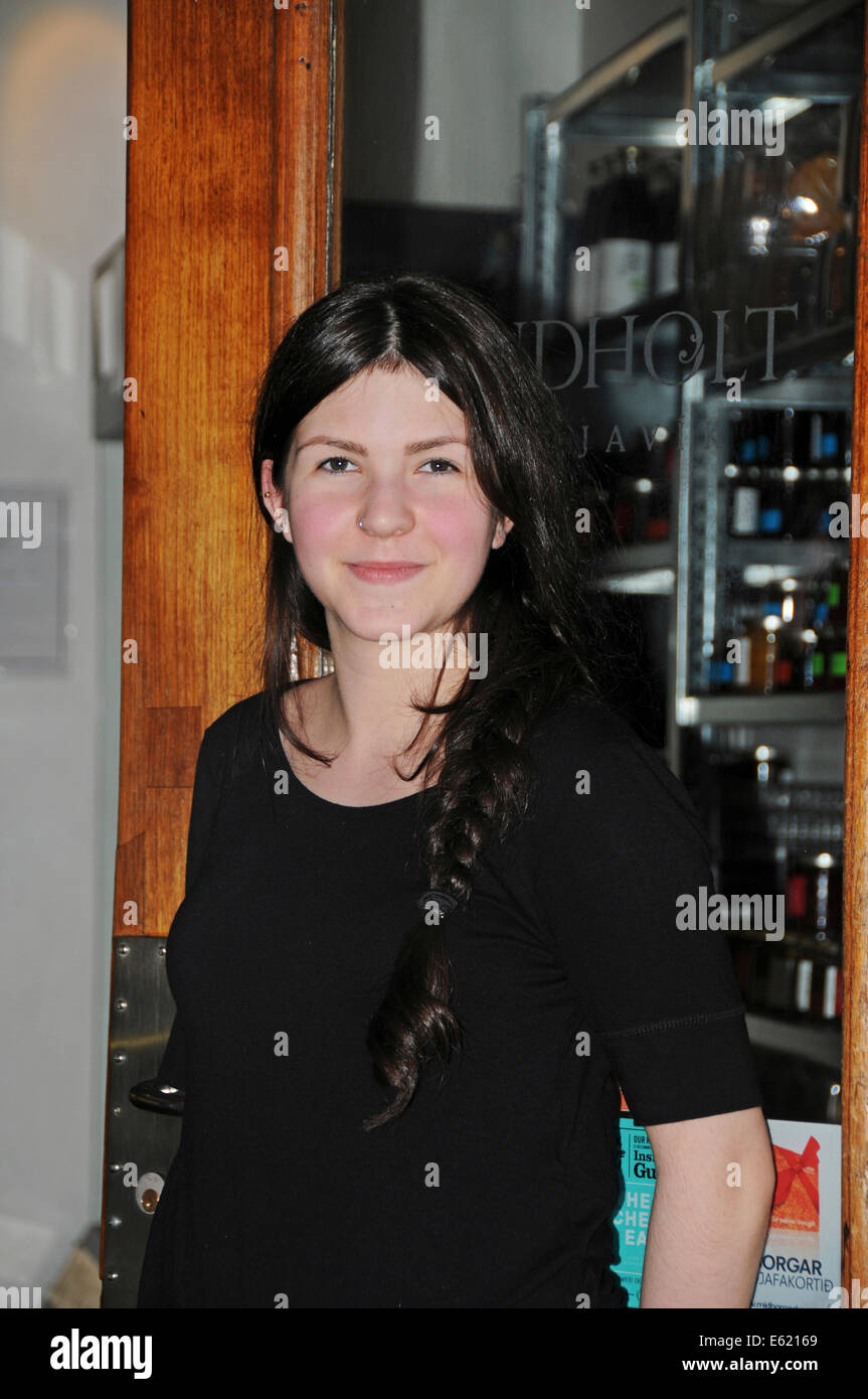 People and faces along streets of Reykjavik in Iceland. The girl working in the bakery. Stock Photo