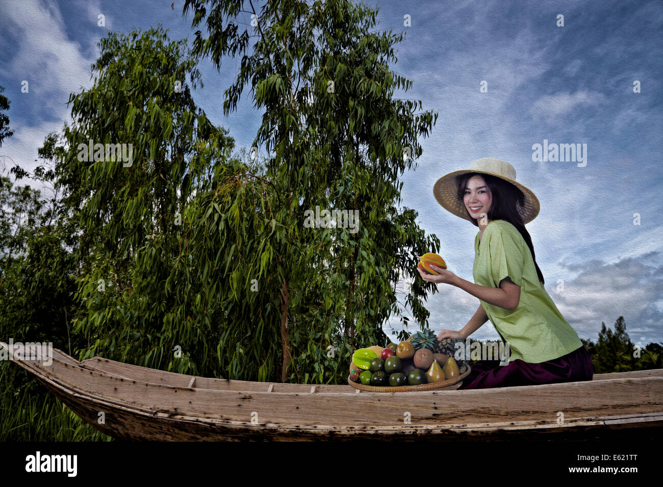 Thailand woman featured on a billboard advertisement against a rural background scene. Stock Photo