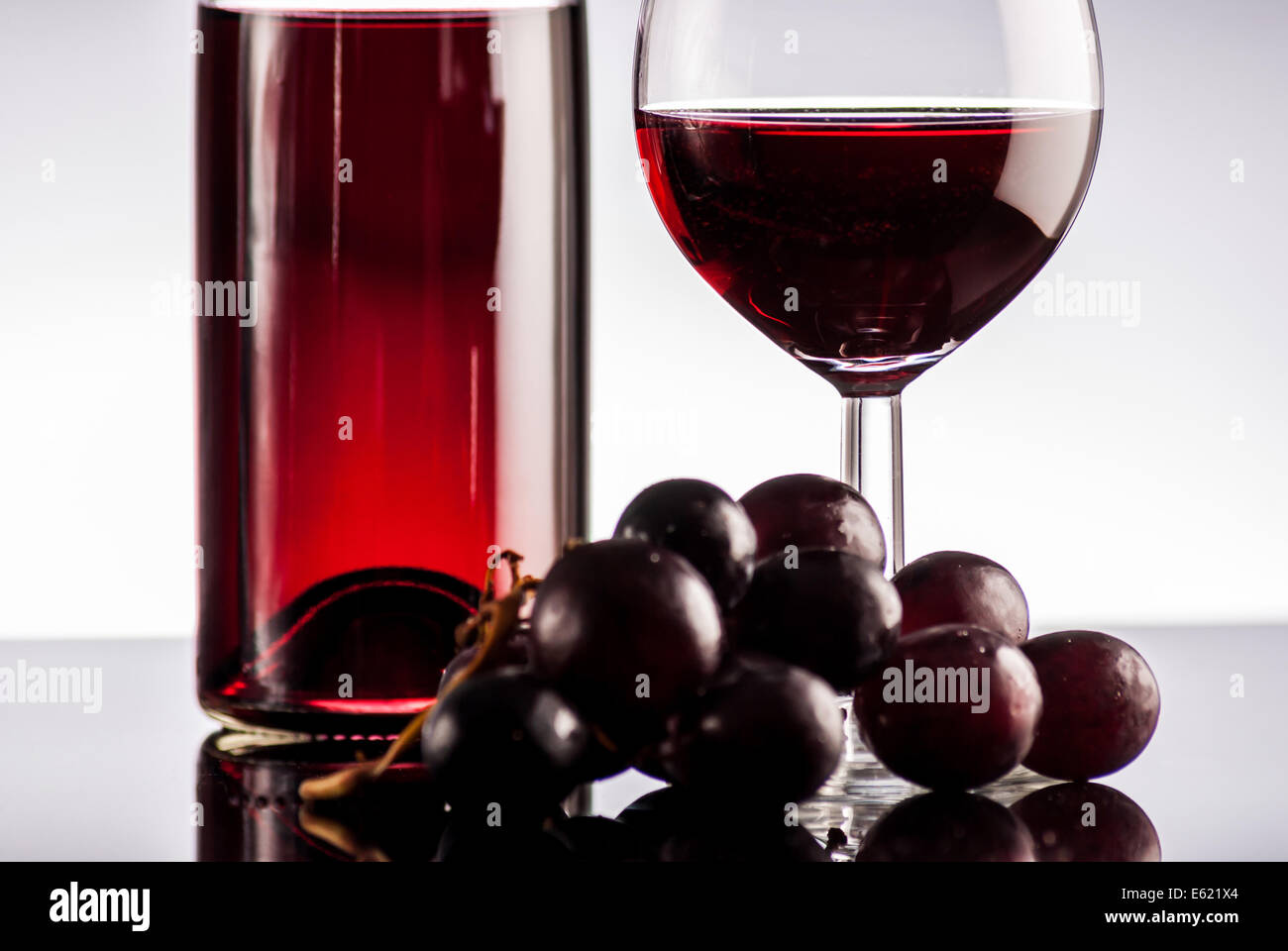 Red wine in bottle on black reflect background Stock Photo - Alamy