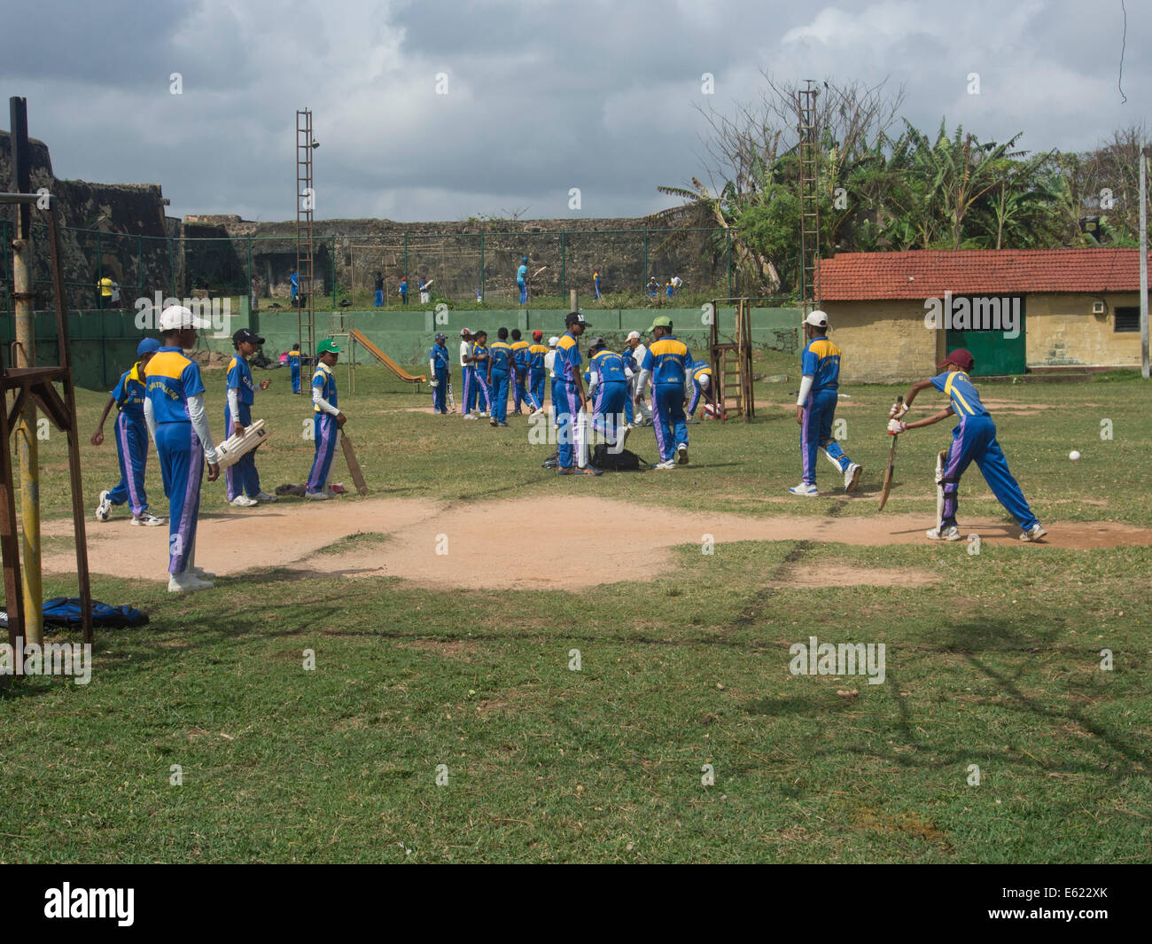 Young people play cricket in the old town in the Fort area in the historical city of Galle, in Sri Lanka Stock Photo
