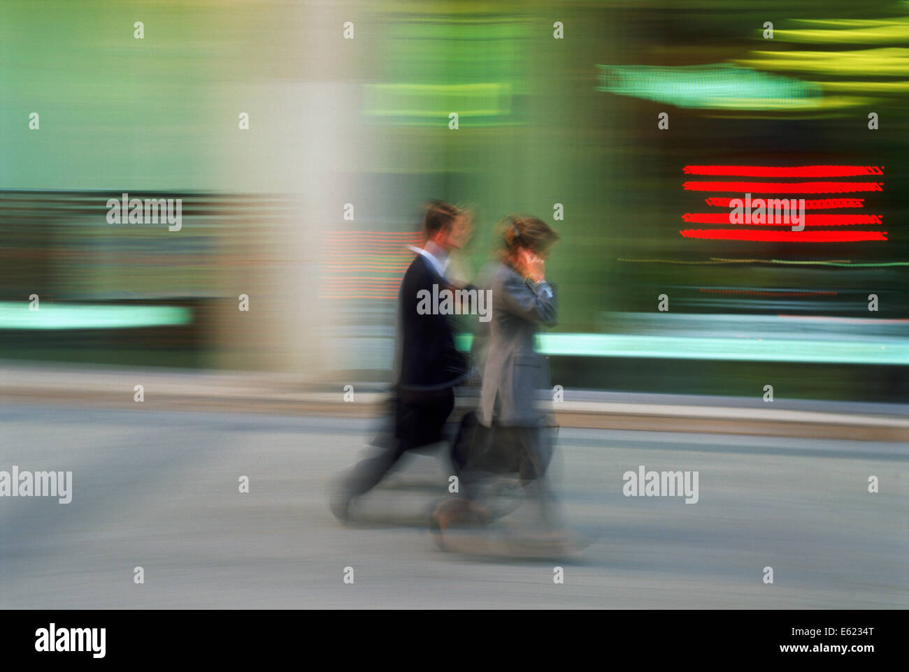 Business man and woman in motion on city street in USA Stock Photo